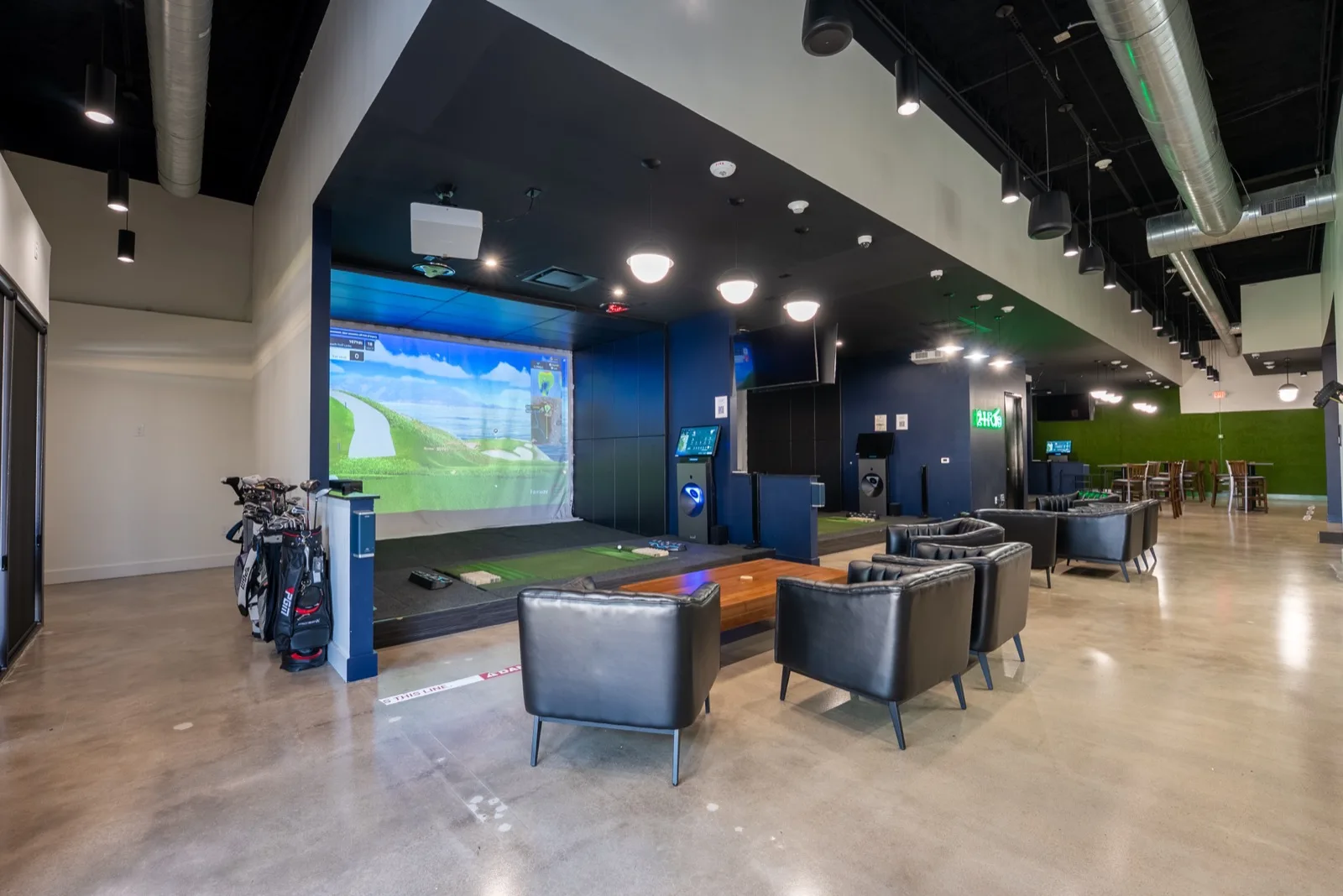 The main floor at 2-1-Fore Golf in Richardson, Texas, with a Golfzon NX bay and lounge seating